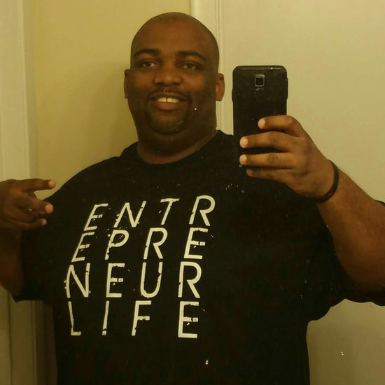 Customer wearing Entrepreneur Life Logo T-shirt